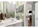 The powder room features modern fixtures and a neutral color palette at 5404 Trumpet Vine Se Trl, Mableton, GA 30126
