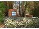 The community entrance sign of Vinings Cove is surrounded by lush greenery, creating a welcoming and established neighborhood feel at 5404 Trumpet Vine Se Trl, Mableton, GA 30126