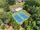 Aerial view featuring tennis courts, a pool, and clubhouse, surrounded by lush greenery, offering resort-style amenities at 5404 Trumpet Vine Se Trl, Mableton, GA 30126