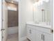 Bright bathroom with double vanity, white cabinets, and tiled shower visible through doorway at 5611 Meadowstone Walk, Kennesaw, GA 30152