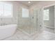 Bright bathroom featuring a modern soaking tub and a glass-enclosed shower at 5611 Meadowstone Walk, Kennesaw, GA 30152
