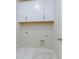 Functional laundry area with white cabinets and utility connections at 5611 Meadowstone Walk, Kennesaw, GA 30152