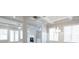Bright living room with coffered ceilings, fireplace, built-in shelving and large windows at 5611 Meadowstone Walk, Kennesaw, GA 30152