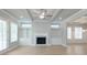 Cozy living room featuring a fireplace with built-in shelves and hardwood floors at 5611 Meadowstone Walk, Kennesaw, GA 30152