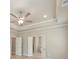 Spacious main bedroom featuring a tray ceiling with a fan and an open bathroom doorway at 5611 Meadowstone Walk, Kennesaw, GA 30152