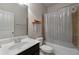 Bathroom with a bathtub, shower, a white toilet, and a sink with dark cabinets at 1222 Lavista Ne Cir, Atlanta, GA 30324