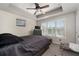 Carpeted bedroom features a large window, ceiling fan, and gray furniture at 1222 Lavista Ne Cir, Atlanta, GA 30324