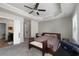 Bedroom features a bench at the foot of the bed, a ceiling fan, and carpet at 1222 Lavista Ne Cir, Atlanta, GA 30324
