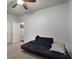 Neutral bedroom featuring a futon, ceiling fan, and adjacent doorway at 1222 Lavista Ne Cir, Atlanta, GA 30324