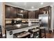 Stylish kitchen featuring dark wood cabinets, granite countertops, stainless steel refrigerator, and breakfast bar seating at 1222 Lavista Ne Cir, Atlanta, GA 30324