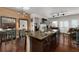 Open-concept kitchen with dark cabinets, granite island, and stainless steel appliances flowing into the living area at 1222 Lavista Ne Cir, Atlanta, GA 30324