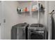 Laundry room includes a washer, dryer, wire rack, and storage at 1222 Lavista Ne Cir, Atlanta, GA 30324