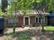 Charming brick home featuring a red tile roof, dark green trim, and a well-maintained front yard at 1225 Cameron Ne Ct, Atlanta, GA 30306