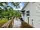Outdoor deck provides ample space with wooded view and partial view of pool at 1430 Mineral Springs Rd, Hoschton, GA 30548