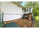 Backside of the house including stairs to the deck with an air conditioner unit placed beneath at 1430 Mineral Springs Rd, Hoschton, GA 30548