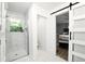 Modern bathroom with a glass-enclosed shower and a sliding barn door for added style at 1430 Mineral Springs Rd, Hoschton, GA 30548