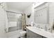Well-lit bathroom with modern fixtures, a shower/tub combo, and farmhouse-style decor at 1430 Mineral Springs Rd, Hoschton, GA 30548