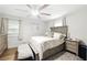 Cozy bedroom with a bed, bedside tables, and a ceiling fan at 1430 Mineral Springs Rd, Hoschton, GA 30548