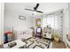 Bright Bedroom with a crib, play area, and natural light from the window at 1430 Mineral Springs Rd, Hoschton, GA 30548