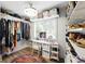 Walk-in closet with custom shelves and rods, and a vanity area at 1430 Mineral Springs Rd, Hoschton, GA 30548
