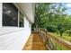 Wooden deck with a view of the surrounding trees and greenery at 1430 Mineral Springs Rd, Hoschton, GA 30548