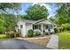 Charming single Gathering home featuring a front porch and tasteful landscaping at 1430 Mineral Springs Rd, Hoschton, GA 30548