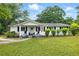 Charming single-story home featuring a well-manicured lawn and an inviting front porch at 1430 Mineral Springs Rd, Hoschton, GA 30548