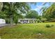 Traditional home with well-manicured lawn and mature trees providing shade at 1430 Mineral Springs Rd, Hoschton, GA 30548
