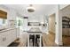 Open-concept kitchen featuring white cabinets, granite countertops, stainless appliances, and a central island with seating at 1430 Mineral Springs Rd, Hoschton, GA 30548