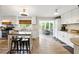 Bright and airy kitchen featuring white cabinetry, granite countertops, stainless steel appliances, and an island with seating at 1430 Mineral Springs Rd, Hoschton, GA 30548