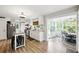 An eat-in kitchen and breakfast nook feature all white cabinets and an island with seating at 1430 Mineral Springs Rd, Hoschton, GA 30548
