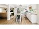 Modern kitchen with an island featuring barstool seating; open layout connects the living room and kitchen at 1430 Mineral Springs Rd, Hoschton, GA 30548