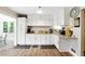 Bright kitchen featuring white cabinetry, granite countertops, and modern appliances at 1430 Mineral Springs Rd, Hoschton, GA 30548