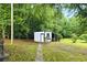 Outbuilding and charming landscaping provide additional space for storage or hobbies at 1430 Mineral Springs Rd, Hoschton, GA 30548