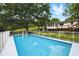 In-ground pool behind the house surrounded by grass and a white fence at 1430 Mineral Springs Rd, Hoschton, GA 30548