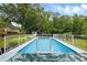 In-ground pool featuring a light blue interior and a white fence that surrounds it at 1430 Mineral Springs Rd, Hoschton, GA 30548