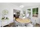 Sunroom features shiplap, lots of light, a round table and view to the yard at 1430 Mineral Springs Rd, Hoschton, GA 30548
