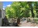 Back deck featuring outdoor seating with a table and lush green trees in the background at 2458 Zachary Woods Dr, Marietta, GA 30064