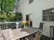 Back deck featuring a metal table and chairs, with a vase of flowers for a cozy outdoor setting at 2458 Zachary Woods Dr, Marietta, GA 30064