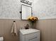 Stylish powder room with decorative wallpaper, modern fixtures, and a sleek vanity at 2458 Zachary Woods Dr, Marietta, GA 30064
