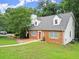 Beautiful brick home featuring shutters, dormers, manicured lawn, and inviting walkway at 2458 Zachary Woods Dr, Marietta, GA 30064