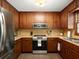 Bright kitchen with wood cabinets, stainless steel appliances, and ample counter space at 2458 Zachary Woods Dr, Marietta, GA 30064