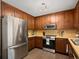 Well-lit kitchen featuring stainless steel appliances, wood cabinets, and light countertops at 2458 Zachary Woods Dr, Marietta, GA 30064
