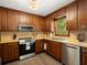 Charming kitchen featuring wood cabinets, stainless steel appliances, and a window at 2458 Zachary Woods Dr, Marietta, GA 30064