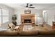 A spacious living room featuring a brick fireplace, natural light, ceiling fan, and stylish furniture at 2458 Zachary Woods Dr, Marietta, GA 30064