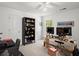 Bright office featuring a ceiling fan, black bookcase, and a wooden desk with two computer monitors at 2458 Zachary Woods Dr, Marietta, GA 30064