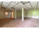 Finished basement with paneled ceiling, carpet and white columns at 2738 Westminister Nw Ln, Conyers, GA 30012