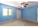 Comfortable bedroom featuring carpet, a ceiling fan, window with natural light, and closet for ample storage at 2738 Westminister Nw Ln, Conyers, GA 30012
