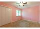 Cozy bedroom with ceiling fan and carpeted floor at 2738 Westminister Nw Ln, Conyers, GA 30012