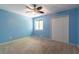 Cozy bedroom featuring carpet, a ceiling fan, window with natural light, and closet for ample storage at 2738 Westminister Nw Ln, Conyers, GA 30012